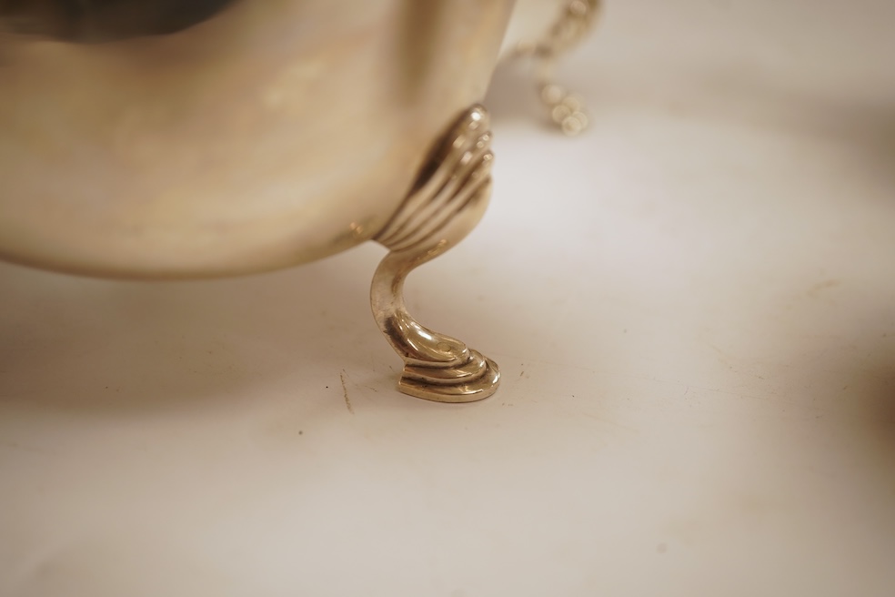 A pair of George V silver sauceboats, with cut borders and flying scroll handles, on three hoof feet, by J.B. Chatterley & Co Ltd, Birmingham, 1928, length 19.3cm, 19.3oz, together with a pair of silver plated Elkington